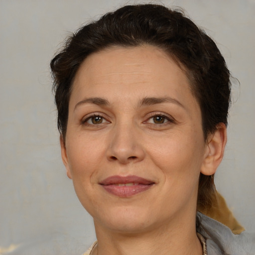 Joyful white adult female with short  brown hair and brown eyes