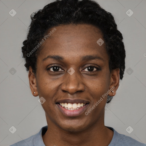 Joyful black young-adult female with short  black hair and brown eyes