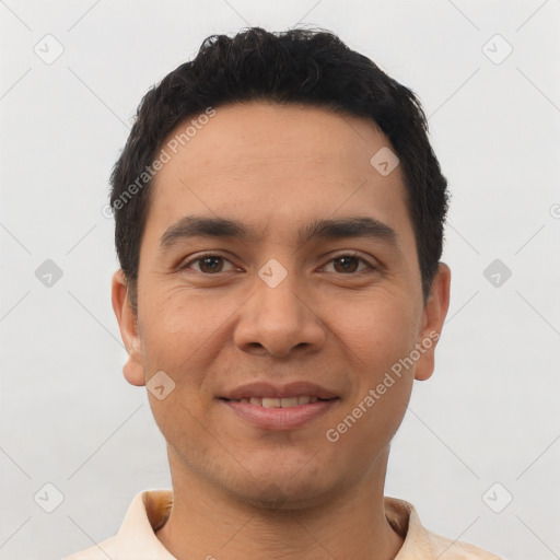 Joyful latino young-adult male with short  black hair and brown eyes