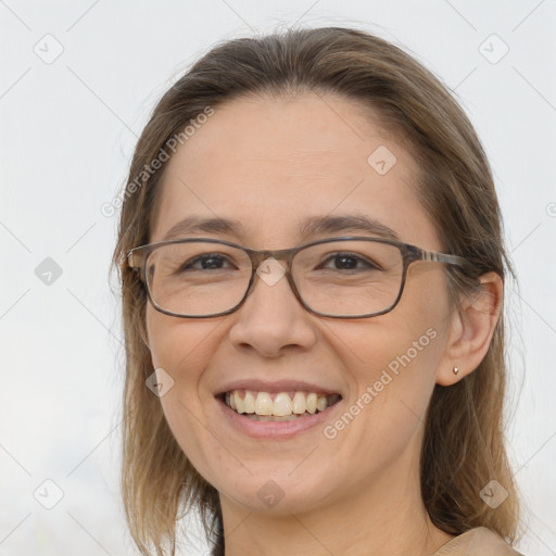 Joyful white adult female with medium  brown hair and brown eyes