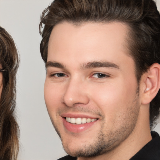 Joyful white young-adult male with medium  brown hair and brown eyes