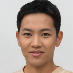 Joyful asian young-adult male with short  brown hair and brown eyes