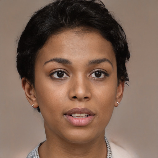 Joyful latino young-adult female with short  brown hair and brown eyes