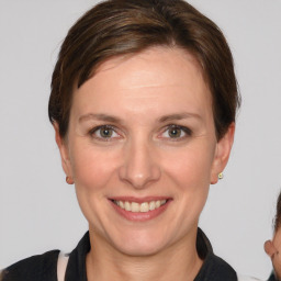 Joyful white adult female with short  brown hair and brown eyes