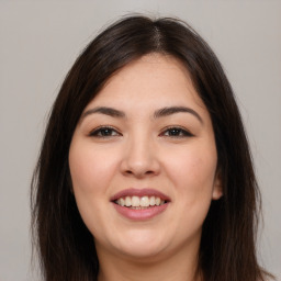 Joyful white young-adult female with long  brown hair and brown eyes