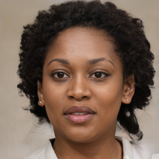 Joyful black young-adult female with medium  black hair and brown eyes