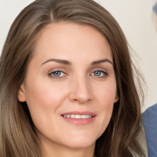 Joyful white young-adult female with long  brown hair and grey eyes