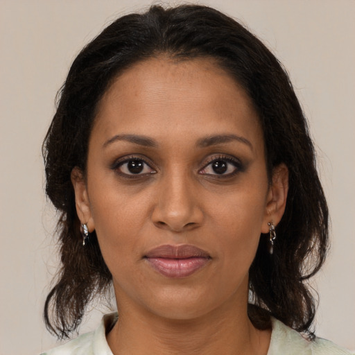 Joyful black young-adult female with medium  brown hair and brown eyes