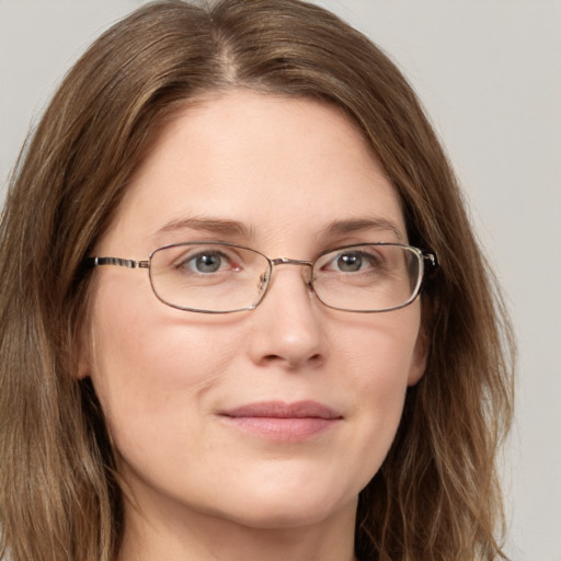 Joyful white adult female with long  brown hair and grey eyes