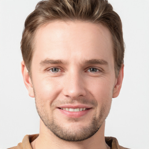 Joyful white young-adult male with short  brown hair and grey eyes