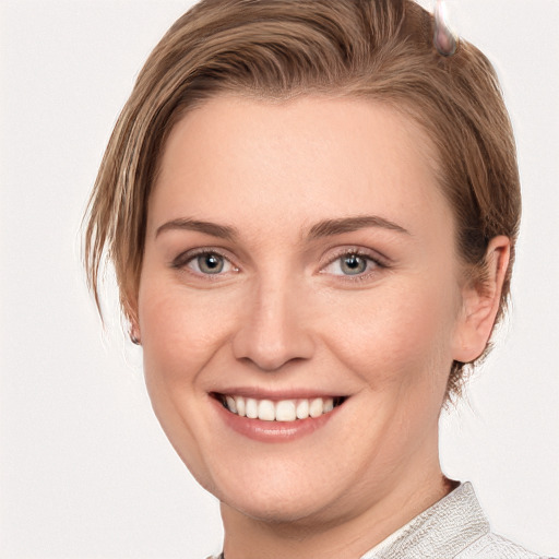 Joyful white young-adult female with medium  brown hair and grey eyes