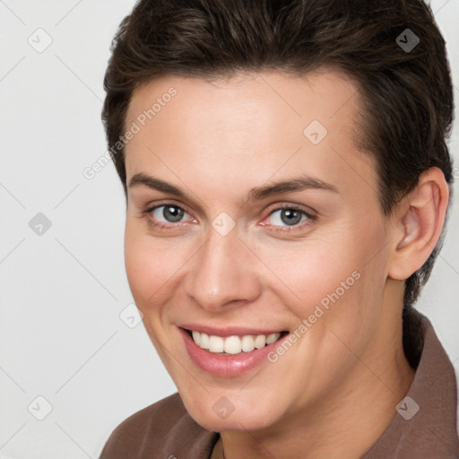 Joyful white young-adult female with short  brown hair and brown eyes