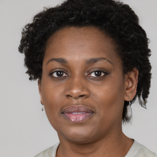 Joyful black adult female with short  brown hair and brown eyes