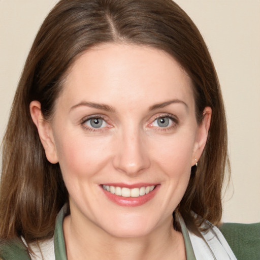 Joyful white young-adult female with medium  brown hair and blue eyes