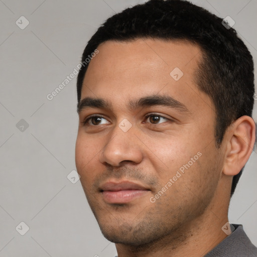 Joyful white young-adult male with short  black hair and brown eyes