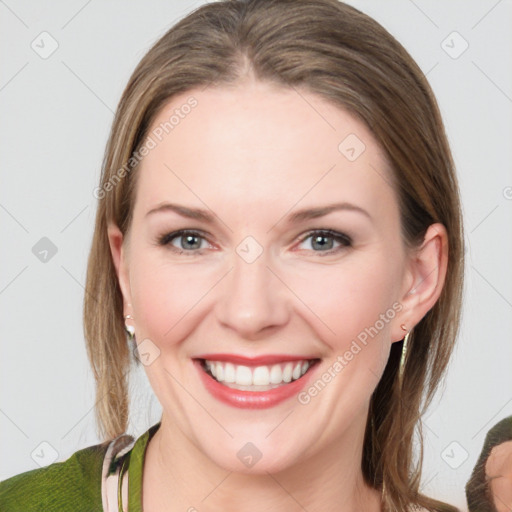 Joyful white young-adult female with medium  brown hair and blue eyes