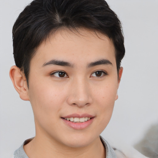 Joyful asian young-adult female with short  brown hair and brown eyes