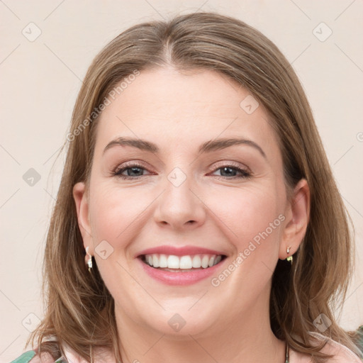 Joyful white young-adult female with medium  brown hair and grey eyes