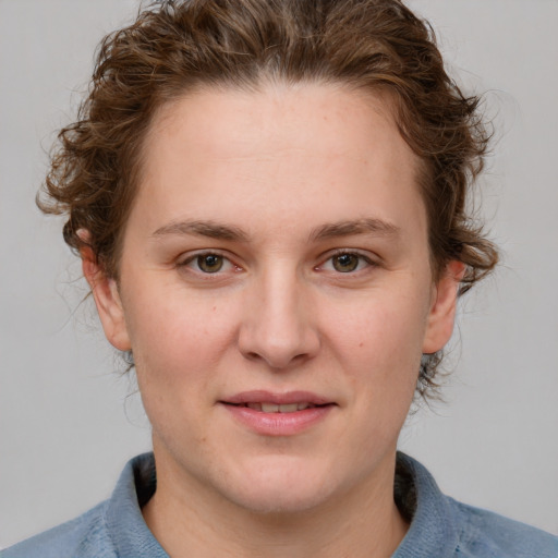 Joyful white young-adult female with medium  brown hair and blue eyes