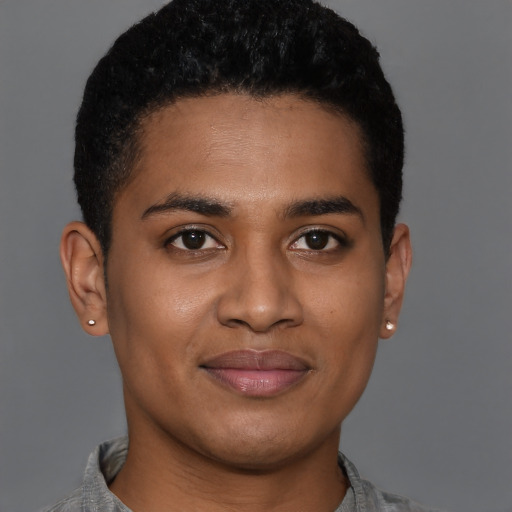 Joyful black young-adult male with short  brown hair and brown eyes