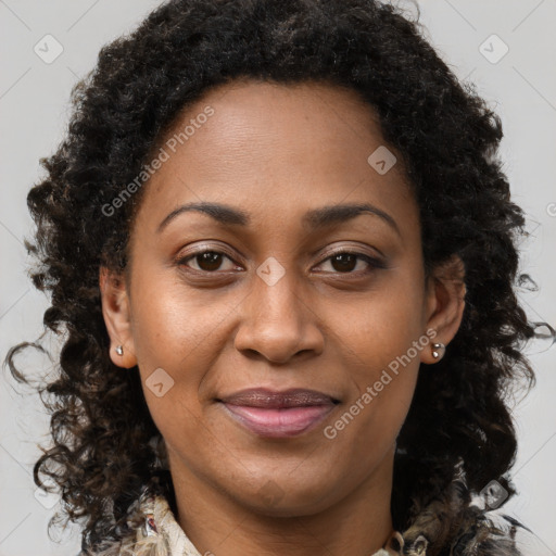 Joyful black adult female with long  brown hair and brown eyes