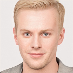 Joyful white young-adult male with short  brown hair and blue eyes