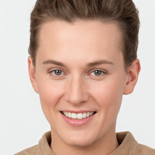 Joyful white young-adult female with short  brown hair and grey eyes