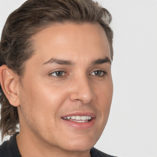 Joyful white young-adult male with medium  brown hair and brown eyes