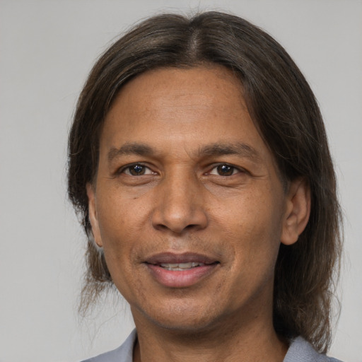 Joyful white adult male with medium  brown hair and brown eyes