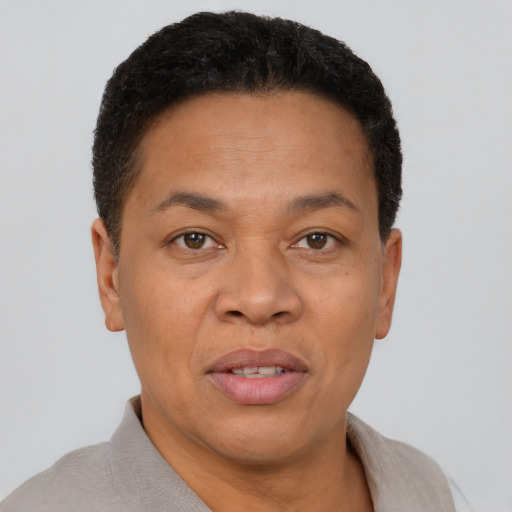 Joyful black adult male with short  brown hair and brown eyes