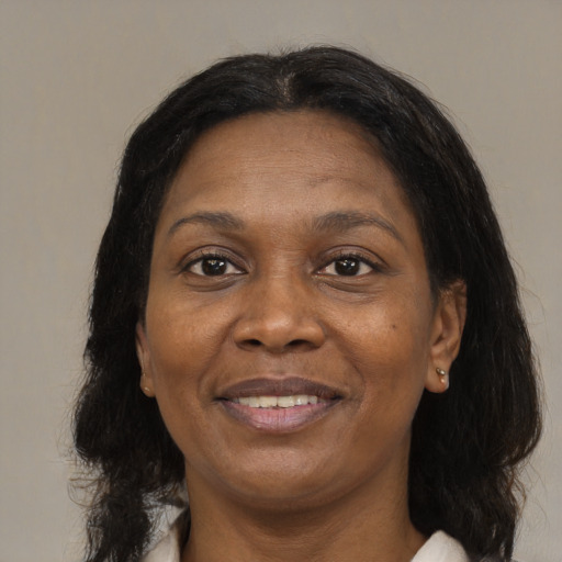 Joyful black adult female with medium  brown hair and brown eyes