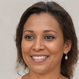 Joyful white adult female with medium  brown hair and brown eyes