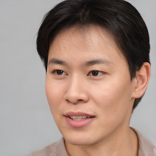 Joyful asian young-adult female with short  brown hair and brown eyes