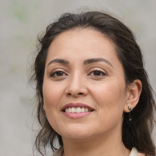 Joyful white adult female with medium  brown hair and brown eyes