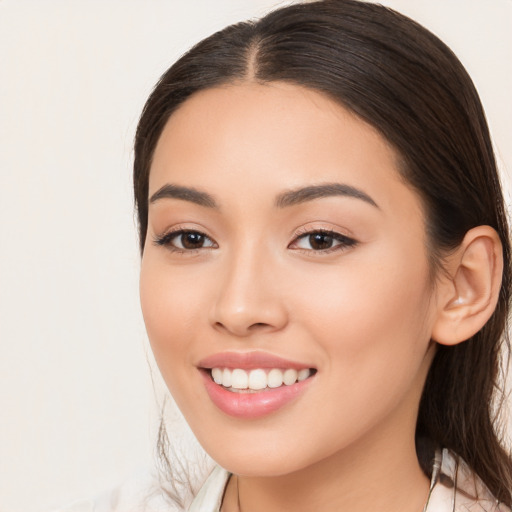 Joyful white young-adult female with long  brown hair and brown eyes