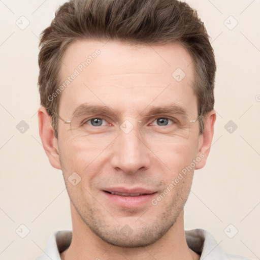 Joyful white adult male with short  brown hair and grey eyes