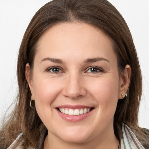 Joyful white young-adult female with long  brown hair and grey eyes