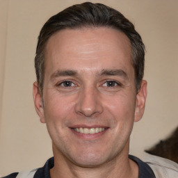 Joyful white adult male with short  brown hair and brown eyes