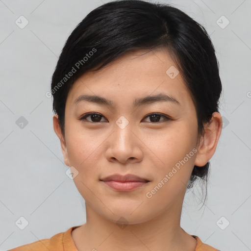 Joyful asian young-adult female with medium  black hair and brown eyes