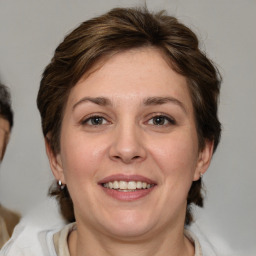 Joyful white adult female with medium  brown hair and brown eyes