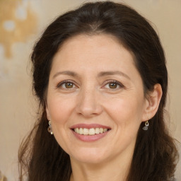 Joyful white adult female with long  brown hair and brown eyes