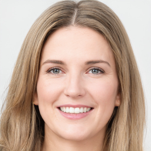 Joyful white young-adult female with long  brown hair and green eyes