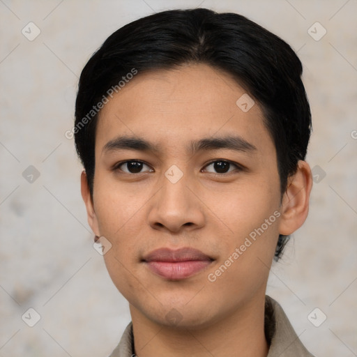 Joyful asian young-adult male with short  black hair and brown eyes