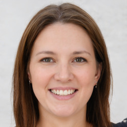 Joyful white young-adult female with long  brown hair and grey eyes