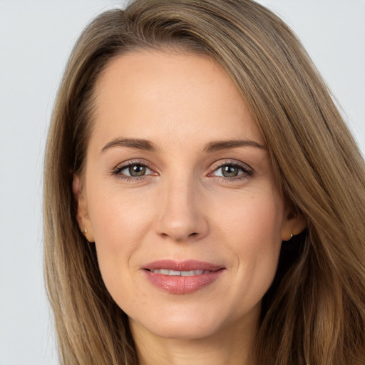 Joyful white adult female with long  brown hair and brown eyes