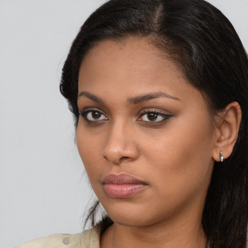 Neutral latino young-adult female with long  brown hair and brown eyes