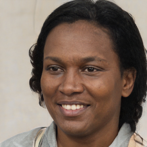 Joyful latino young-adult female with medium  black hair and brown eyes