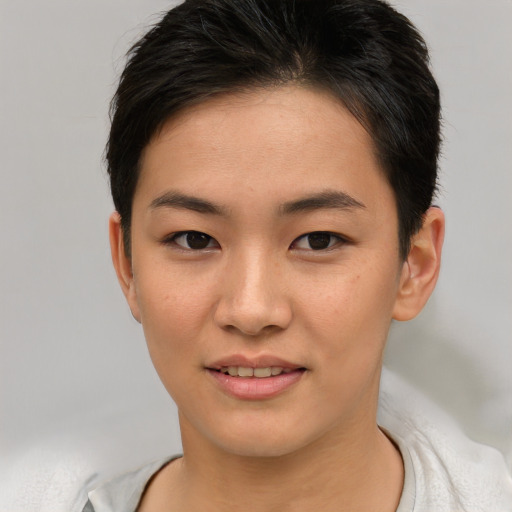 Joyful asian young-adult female with short  brown hair and brown eyes