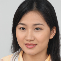 Joyful asian young-adult female with long  brown hair and brown eyes