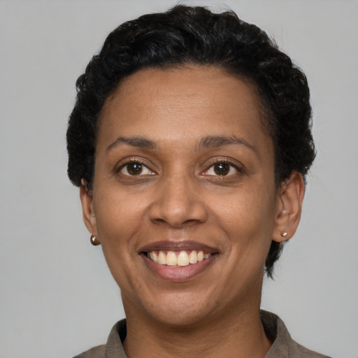 Joyful latino adult female with short  brown hair and brown eyes